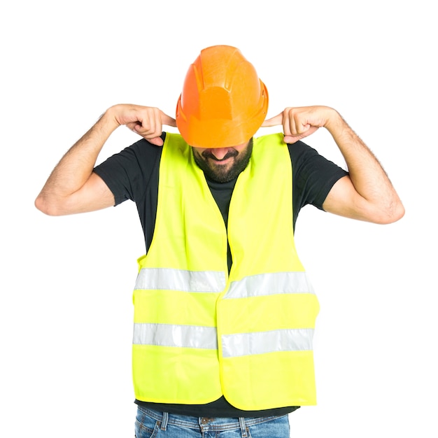 Workman covering his ears over white background