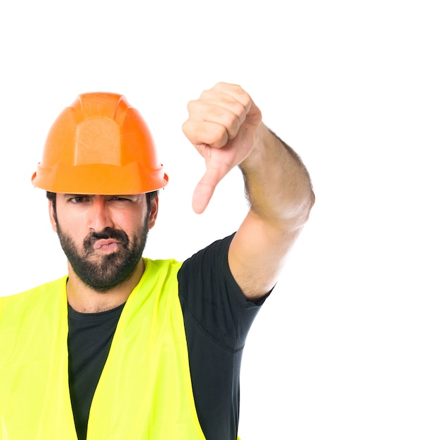 Free photo workman doing a bad signal over white background