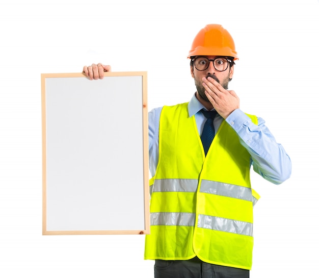 Free photo workman holding empty placard