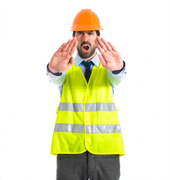 workman making stop sign over white background