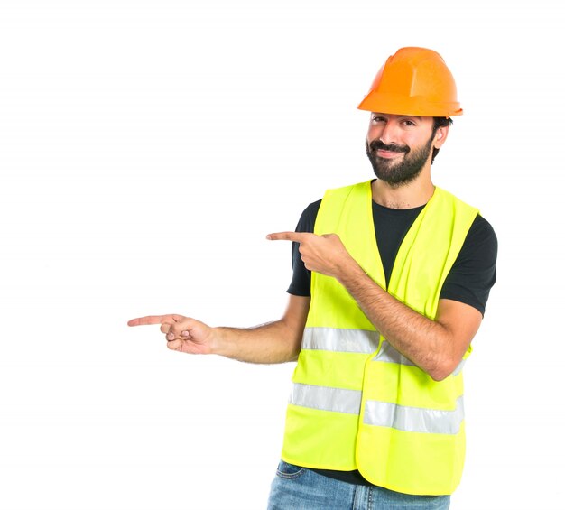 Workman pointing to the latertal over white background