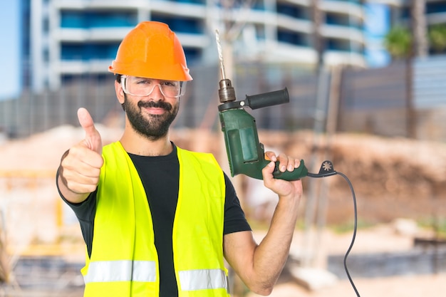 Free Photo workman with drill over white background