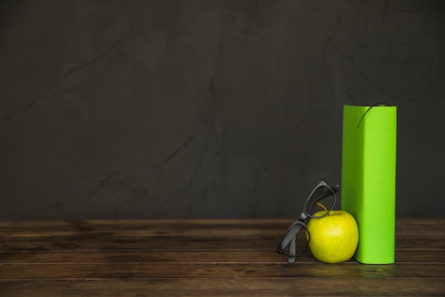 Free Photo workplace with book apple and glasses 