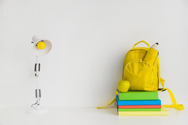 Workplace with books and yellow backpack