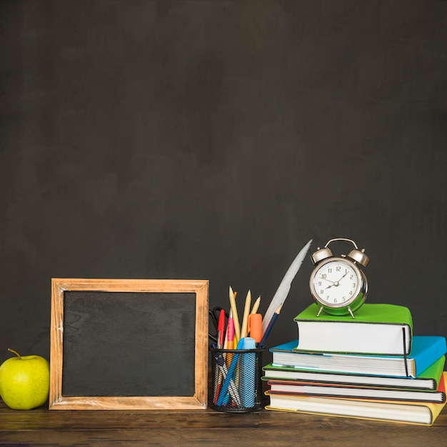 Workplace with chalkboard books and stationery