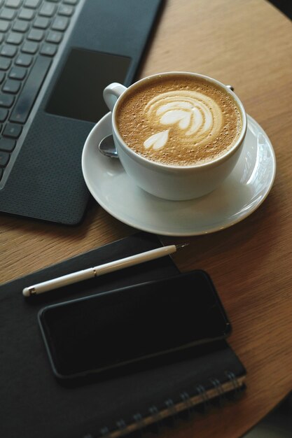 Workplace with coffee cup and laptop