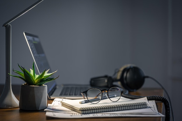 Workplace with headphones and laptop in the evening copy space