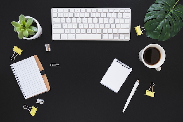 Workplace with keyboard cup and stationery