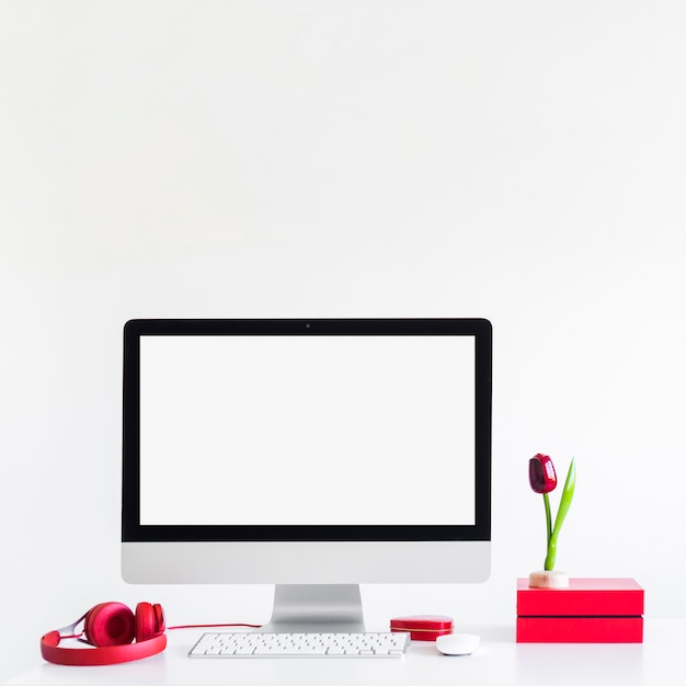 Free photo workplace with keyboard near monitor, computer mouse and headphones