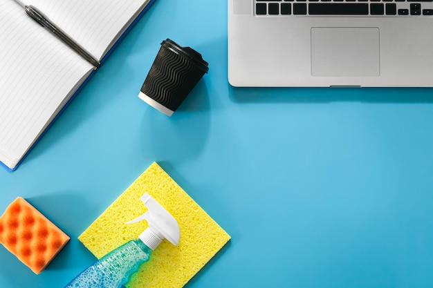 Free photo workplace with laptop and cleaning products flat lay