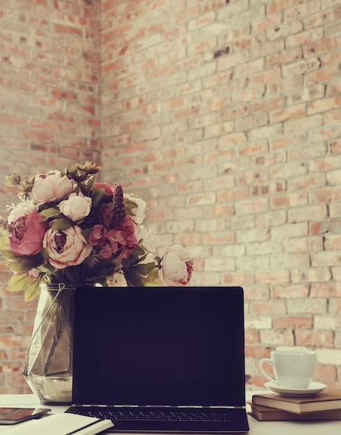 Free Photo workplace with laptop and coffee cup