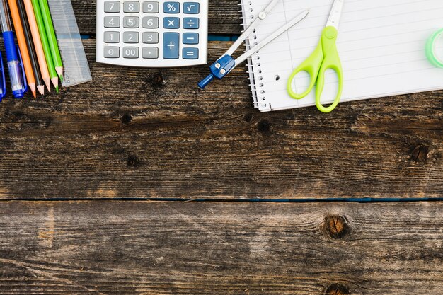 Workplace with notebook calculator and stationery 