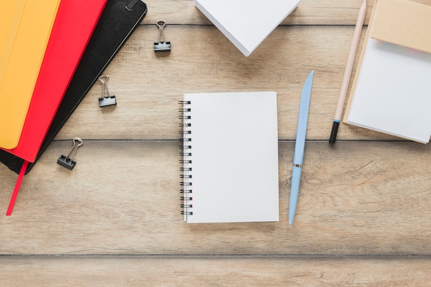 Free photo workplace with notebook placed near stationery on wooden table