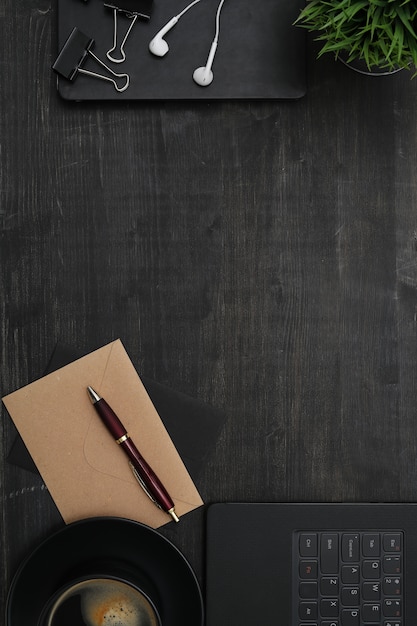 Workplace with smartphone, notebook, on black table. Top view