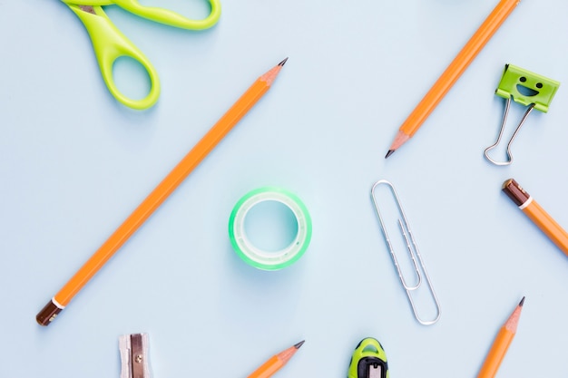 Workplace with stationery on blue background 