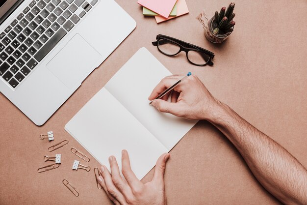 Workspace concept with hands writing