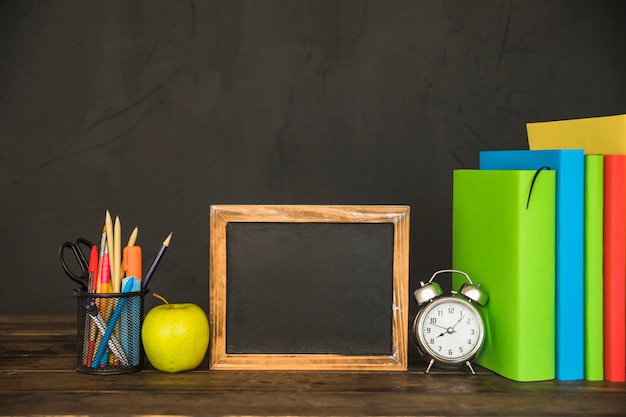 Workspace with books and blackboard frame