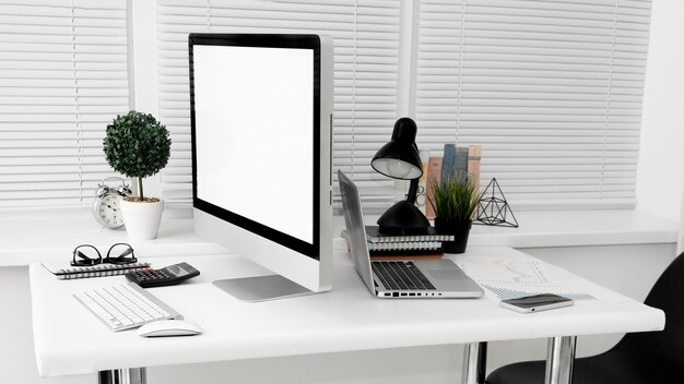 Workspace with laptop and computer screen