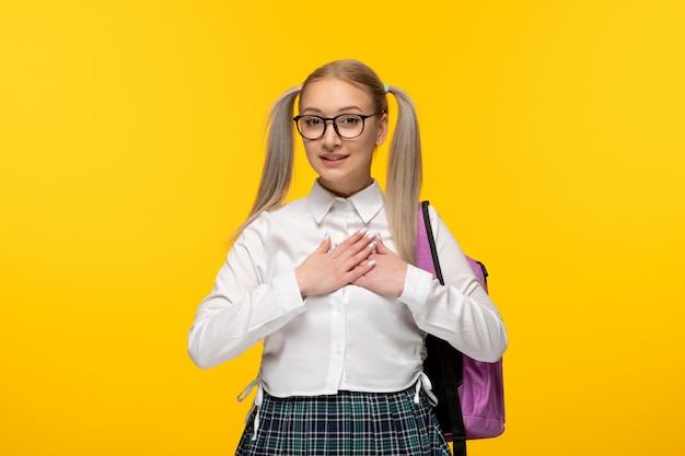 World book day smiling happy cute schoolgirl in uniform holding hands together