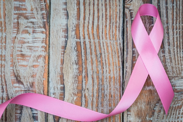 Free photo world cancer day : breast cancer awareness ribbon on wood backgr