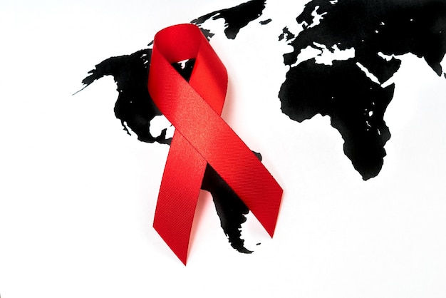 Free photo world cancer day : breast cancer awareness ribbon on world map .