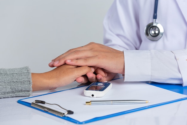 Free photo world diabetes day; doctor holding patient hand's