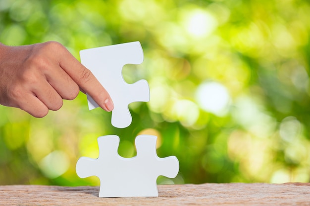 World Habitat Day,close up picture of  a piece of white jigsaw in hand