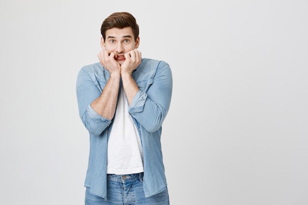 Free photo worried brunette man looking scared, trembling fear