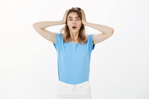 Free Photo worried and concerned panicking blond woman grab head and looking shocked