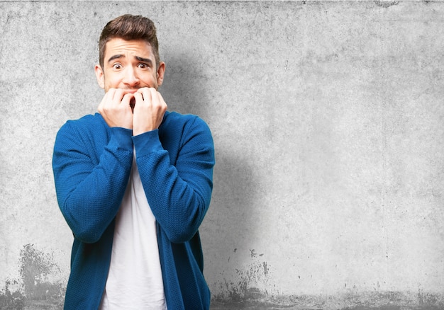 Free photo worried man biting his nails