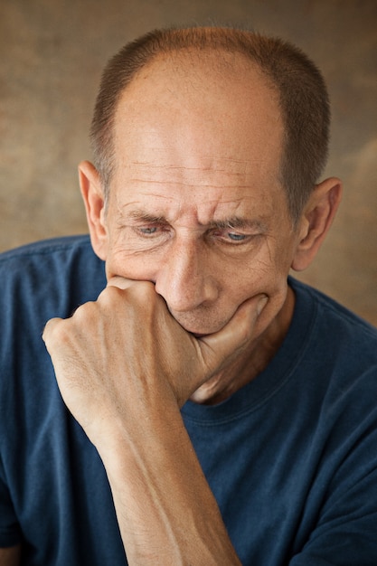 Free photo worried mature man touching his head.