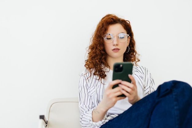 Worried woman sitting on sofa at home and having negative phone talk hearing bad news or arguing