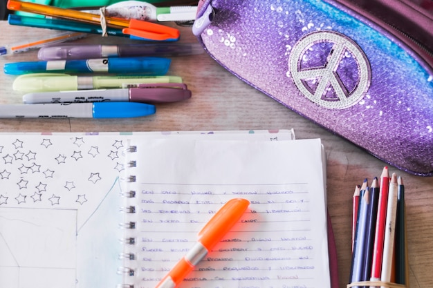 Free photo writing supplies and pencil case lying near notebook