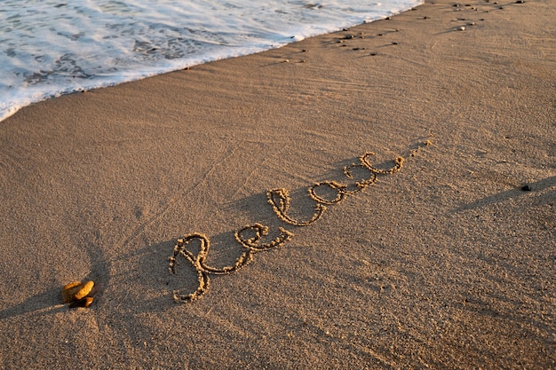 Free Photo writing words in the sand