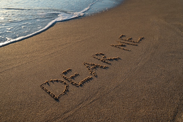 Free photo writing words in the sand