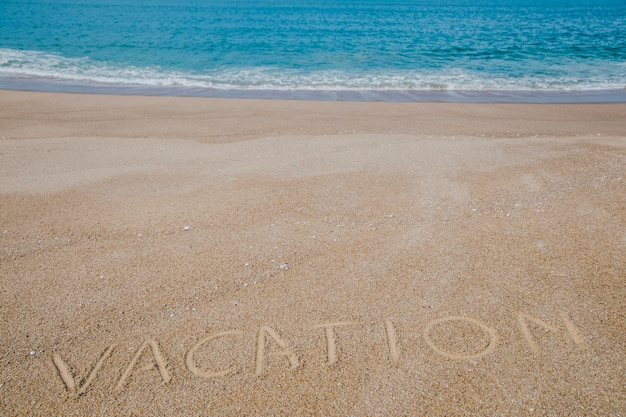 Free photo written word on sand and ocean