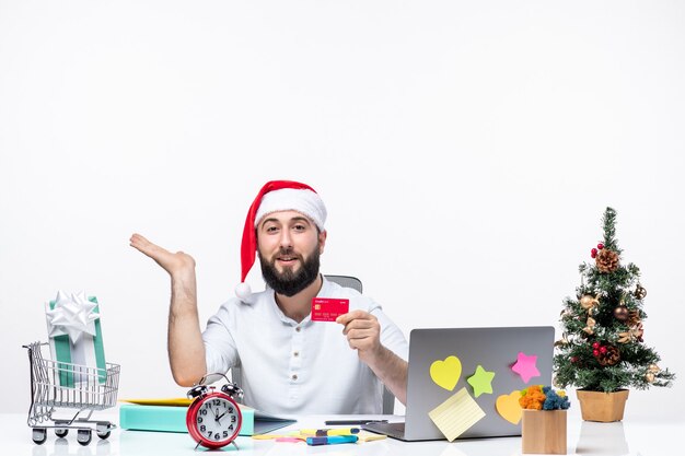 xmas mood with young adult with santa claus hat and holding bank card and pointing something