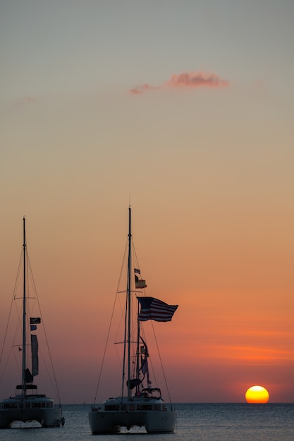 Free Photo yacht in the sea during sunset