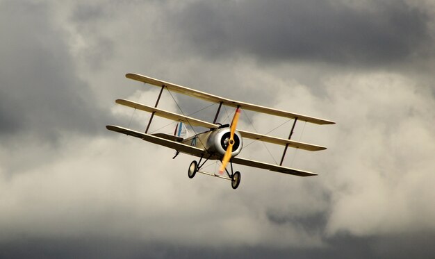 Yellow Antonov an-2 in the dark cloudy sky