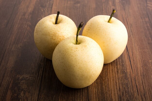 Yellow apples on a wooden table