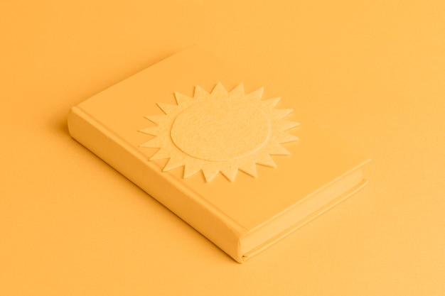 Free photo yellow background with isometric book