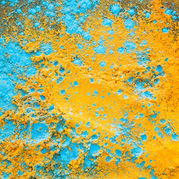 Free photo yellow blue powder on table