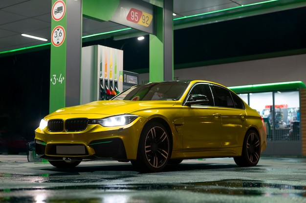 Yellow car at gas station