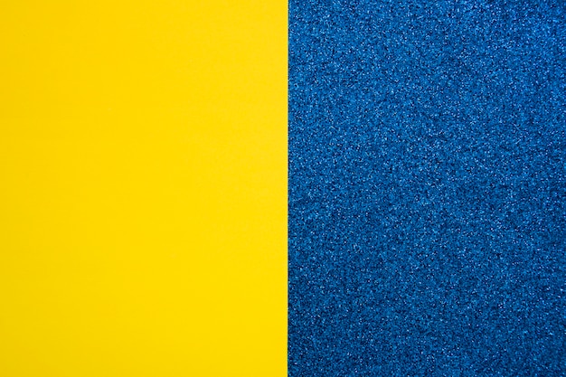 Free photo yellow cardboard paper on blue carpet