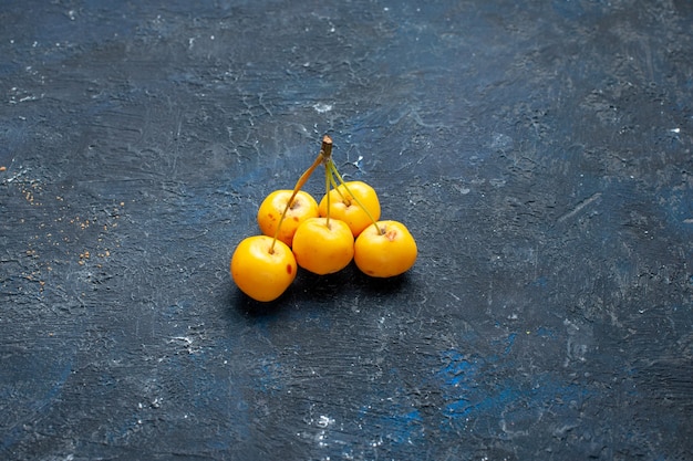 Free Photo yellow cherries isolated on dark desk