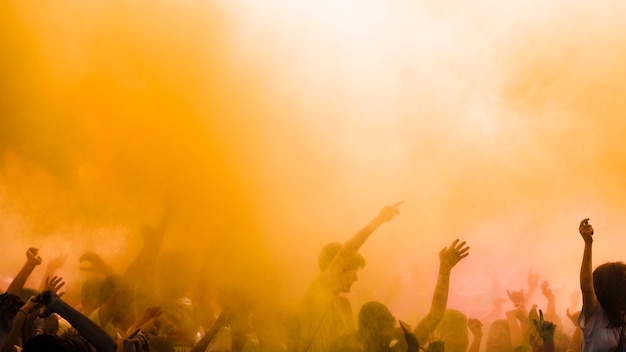 Free photo yellow color explode over the crowd enjoying holi festival