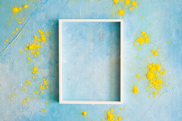 Yellow color powder around the white border frame on painted wall