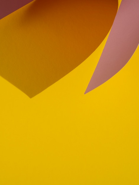 Free photo yellow copy space of abstract paper shapes with shadow