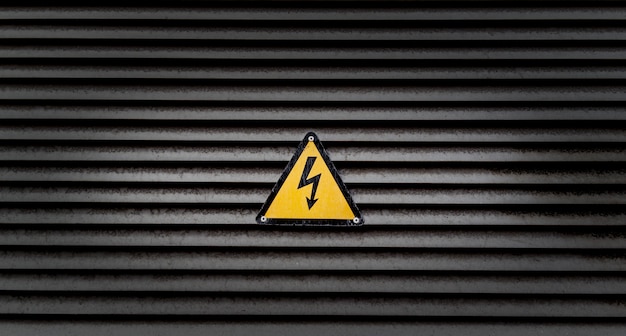 Free Photo yellow danger sign on a black striped wall