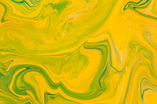 Yellow fluid acrylic pour painting